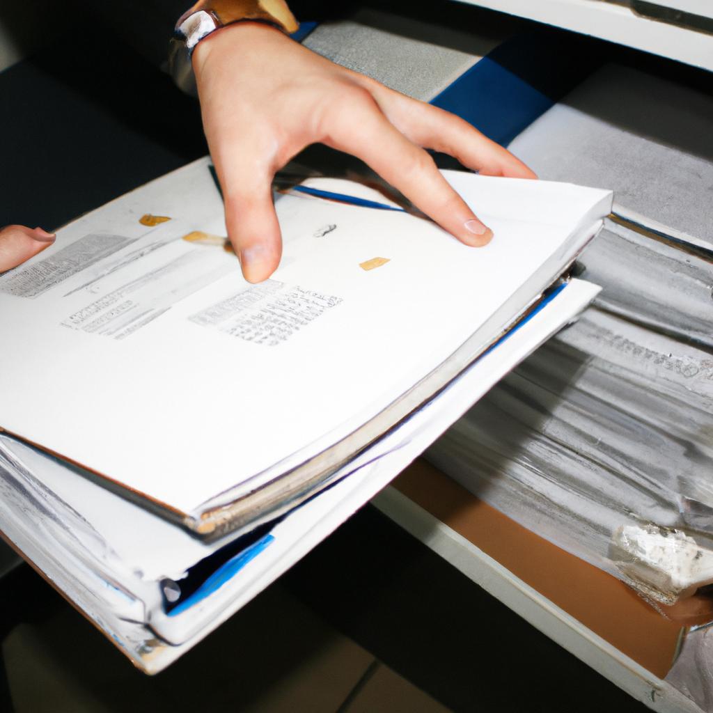 Person reviewing documents and files